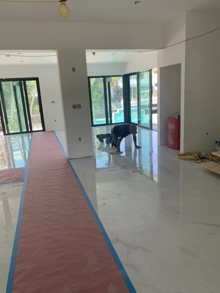 Flooring A dog is standing in the middle of a room.
